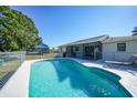 Relaxing backyard pool with a screened-in patio area, perfect for outdoor entertainment and leisure at 2621 Larkspur Dr, Punta Gorda, FL 33950