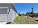 Exterior view of the house showing siding and the side of the garage at 26456 View Dr, Punta Gorda, FL 33983
