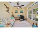 Cozy home office featuring a comfortable sofa, large windows offering natural light, and a functional workspace at 2666 Barry Rd, North Port, FL 34286