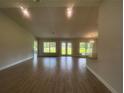 Open-concept living room features wood-look tile flooring and an abundance of natural light with views to the back yard at 337 Rosario St, Punta Gorda, FL 33983