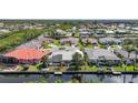 Aerial view of waterfront homes in a neighborhood on a canal with mature trees and tropical landscaping at 3513 Dileuca St, Punta Gorda, FL 33950