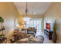 Comfortable living room with sliding glass doors to a balcony and a dining area at 4000 Bal Harbor Blvd # 124, Punta Gorda, FL 33950