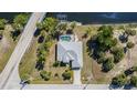 Aerial view showcasing a property, pool, waterfront canal access and neighborhood at 4010 Yucatan Cir, Port Charlotte, FL 33948