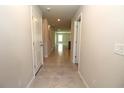 Bright hallway with neutral walls, tile flooring, and recessed lighting at 4071 Conestoga St, Port Charlotte, FL 33948