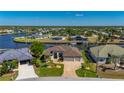 Stunning waterfront property showcasing lush greenery, a boat dock, and a beautiful neighborhood setting at 4174 Perch Cir, Port Charlotte, FL 33948