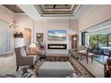 Elegant living room featuring a fireplace, high ceilings, and sliding doors that open to the outdoor lanai at 4174 Perch Cir, Port Charlotte, FL 33948