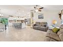 Spacious open-concept living area featuring tile flooring, neutral paint, and a seamless flow into the modern kitchen at 4463 Cromey Rd, North Port, FL 34288
