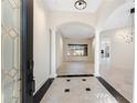 Inviting foyer with high ceilings, decorative columns and tile flooring at 4676 Tuscana Dr, Sarasota, FL 34241