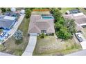 Aerial view of home with pool, complemented by lush landscaping and a private fenced backyard at 657 Hartford Nw Dr, Port Charlotte, FL 33952