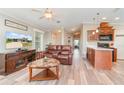 Cozy living room with hardwood floors, and an open-concept layout with kitchen access at 714 Fairmount Dr, North Port, FL 34287