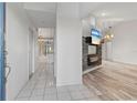 Elegant foyer with tile flooring, a view to the living space, and a decorative fireplace at 719 Ellicott Nw Cir, Port Charlotte, FL 33952