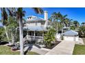 Two story home with neutral colored siding, metal roof and detached garage at 740 W Virginia Ave, Punta Gorda, FL 33950
