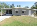 Inviting single-story home features a screened carport, complemented by a well-maintained lawn at 8544 Herbison Ave, North Port, FL 34287