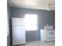 Clean kitchen featuring tile floors, a window for natural light, and white appliances at 8544 Herbison Ave, North Port, FL 34287