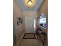 Inviting foyer with tile flooring and tasteful decorations at 1173 Belkton Ave, Port Charlotte, FL 33948