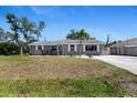 Charming single-story home with neutral paint, a palm tree, and a well-manicured front yard at 1249 Indus, Venice, FL 34293