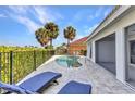 Sparkling pool surrounded by a spacious patio and lush landscaping, perfect for relaxation and outdoor enjoyment at 125 Donna Ct, Punta Gorda, FL 33950