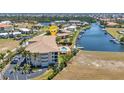 Stunning aerial view of waterfront condo with boat docks and a sparkling community pool at 1349 Aqui Esta Dr # 121, Punta Gorda, FL 33950