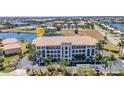Beautiful waterfront condominium building with lush landscaping, ample parking, and waterfront views at 1349 Aqui Esta Dr # 121, Punta Gorda, FL 33950
