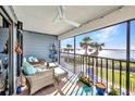 Screened condo balcony with seating offers beautiful ocean views and a peaceful retreat at 1701 Beach Rd # 305, Englewood, FL 34223