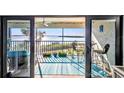 Inviting screened condo balcony with bar-height seating overlooks a tranquil ocean view at 1701 Beach Rd # 305, Englewood, FL 34223