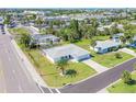 Expansive aerial view of a well-manicured home with a lush green lawn, surrounded by palm trees at 1795 Elinor Pl, Englewood, FL 34223