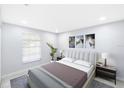 Bright bedroom featuring neutral walls, plush bedding, and stylish artwork at 18263 Ohara Dr, Port Charlotte, FL 33948