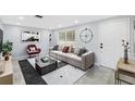 Bright living room features a modern sofa, contemporary art, and ample natural light at 18263 Ohara Dr, Port Charlotte, FL 33948