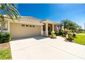 Charming single-Gathering home with a well-manicured lawn and spacious driveway at 1991 Mossy Oak Dr, North Port, FL 34287