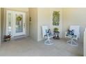 Cozy front porch features comfortable seating, offering a relaxing spot to unwind at 1991 Mossy Oak Dr, North Port, FL 34287
