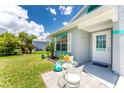 Close-up of home exterior with an outdoor seating area and freshly painted accents at 20016 Sancraft Ave, Port Charlotte, FL 33954