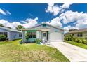 Inviting home exterior featuring a cozy patio and well-maintained lawn at 20016 Sancraft Ave, Port Charlotte, FL 33954