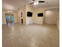 Spacious living area boasting tile floors and multiple TVs, ready for entertaining at 243 Harbor Blvd, Port Charlotte, FL 33954