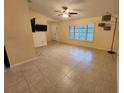 Bright living area with expansive tile floors, neutral walls and a large window for natural light at 243 Harbor Blvd, Port Charlotte, FL 33954