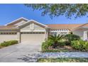 Charming single-story home with a three-car garage, well-manicured landscaping, and a cozy front patio at 2508 Magnolia Cir, North Port, FL 34289