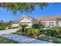 Charming single-story home with a three-car garage, well-manicured landscaping, and a cozy front patio at 2508 Magnolia Cir, North Port, FL 34289
