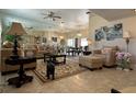 A spacious living room with tile flooring, neutral furniture, and a mirrored wall, creating an inviting atmosphere at 25263 Padre Ln, Punta Gorda, FL 33983