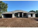 Exterior view of home with block construction and a large front yard at 26209 Madras Ct, Punta Gorda, FL 33983