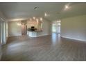 Open-concept living space with tile floors, bright lighting, and seamless flow to the kitchen at 26209 Madras Ct, Punta Gorda, FL 33983