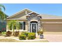 Charming home with stone accents, decorative front door, and well-maintained landscaping at 27854 Arrowhead Cir, Punta Gorda, FL 33982