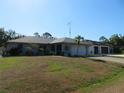 Attractive single-story home with a lush green lawn, complemented by a two-car garage at 296 Milford St, Port Charlotte, FL 33953
