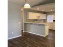 Updated kitchen featuring white cabinets, a breakfast bar, and modern appliances at 3293 Cincinnati St, North Port, FL 34286