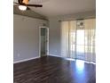Bright living room featuring wood flooring, neutral walls, and sliding glass doors to the backyard at 3293 Cincinnati St, North Port, FL 34286