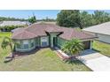 Beautiful home featuring lush landscaping, a welcoming entrance, and a well-maintained lawn at 347 Casale G St, Punta Gorda, FL 33983