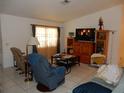 Cozy living room space with tile flooring and natural lighting at 582 Reading Nw St, Port Charlotte, FL 33952