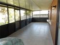 The enclosed patio offers tile flooring, a built-in shelf, and screened windows with views of the yard at 582 Reading Nw St, Port Charlotte, FL 33952