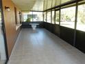 Enclosed patio features tile flooring, a table, and screened windows for a relaxing outdoor experience at 582 Reading Nw St, Port Charlotte, FL 33952