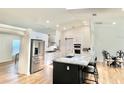 Bright, white kitchen featuring stainless steel appliances, an island, and modern finishes at 6308 Grove Blvd, Punta Gorda, FL 33982