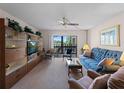 Living room boasts neutral walls, a ceiling fan, and large sliding glass doors leading to the lanai at 72 Boundary Blvd # 226, Rotonda West, FL 33947