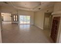 Spacious living room featuring tile flooring, tray ceilings, and sliding glass doors to the pool area at 730 Boundary Blvd, Rotonda West, FL 33947